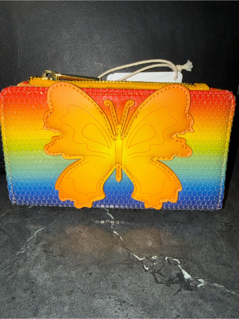 Vibrant Rainbow Zip Wallet with Orange Butterfly Accent
Dollywood Wallet; Lounge